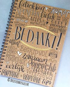 a spiral notebook with writing on it and the words bdnkt written in different languages