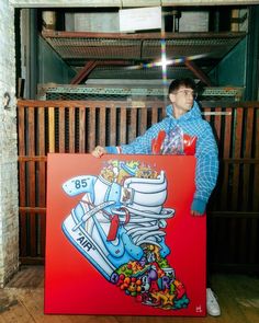 a man holding a large painting in front of him