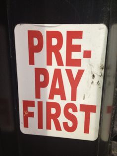 a red and white sign that says pre - pay first