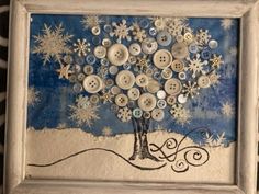 a painting with buttons in the shape of a tree and snowflakes on it