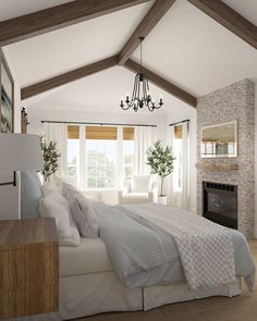 a bedroom with a bed, fireplace and chandelier