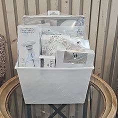 a white plastic container filled with items on top of a wooden table next to a wall