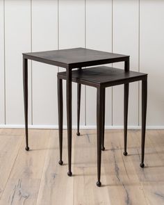 two nesting tables sitting on top of a wooden floor