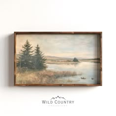 a painting hanging on the wall next to a white wall with a sign that says wild country