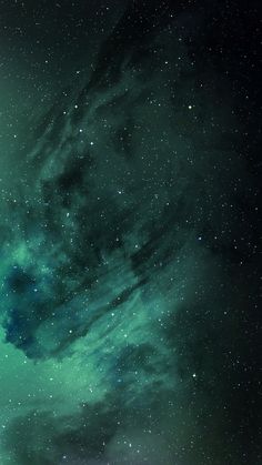 the night sky is filled with stars and bright green lights, as well as dark clouds