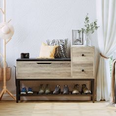 a wooden shoe rack with shoes on it in front of a white curtained wall