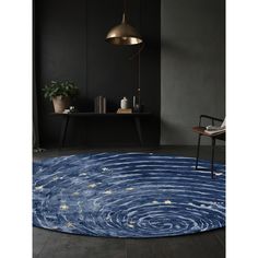 a blue rug with stars on it and a chair in the corner next to it