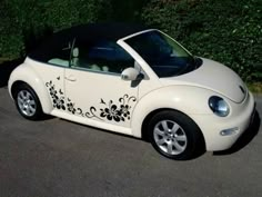 a white car with black flowers painted on it