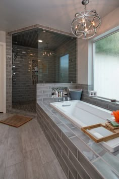 a bathroom with a large bathtub next to a walk in shower