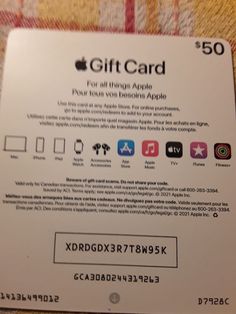 an apple gift card sitting on top of a blanket