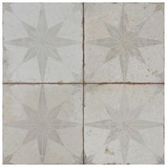 four white and gray star tiles on the floor