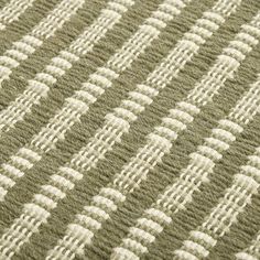 a close up view of a green and white rug