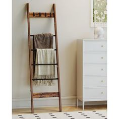 a wooden ladder leaning against a wall in a room with a rug on the floor