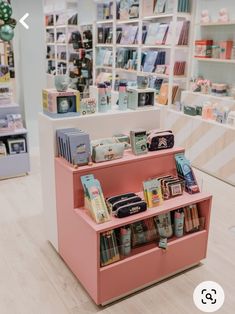 the inside of a book store with pink shelves and books on it's sides