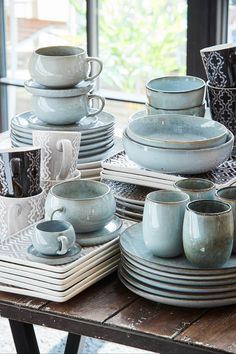 a table topped with lots of plates and cups