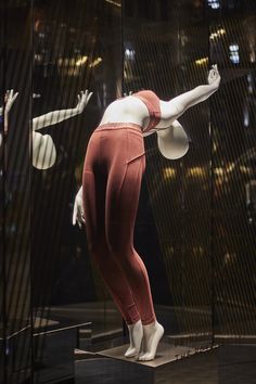 a mannequin is standing in front of a window