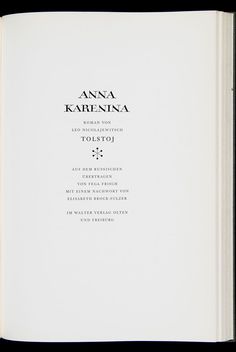 an open book with black writing on the front and back cover, in white paper