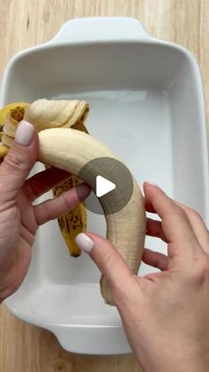 a person is peeling a banana into a bowl