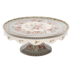 an ornately decorated cake plate with flowers on it