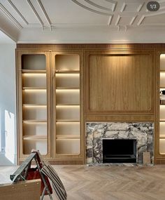 an empty living room with built in bookshelves