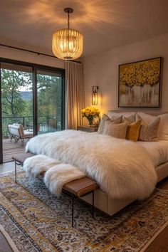 a large white bed sitting inside of a bedroom next to a sliding glass door leading to a patio