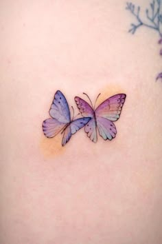 two butterflies on the back of a woman's stomach