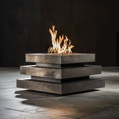 a square fire pit sitting on top of a stone floor