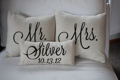 three personalized pillows with names on them