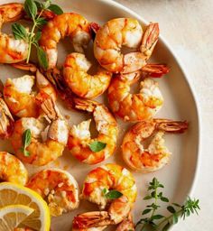 shrimp and lemon on a plate with garnish