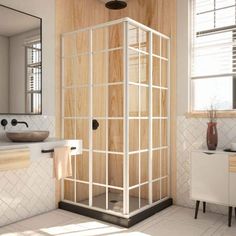 a bathroom with a shower, sink and mirror on the wall is shown in this image