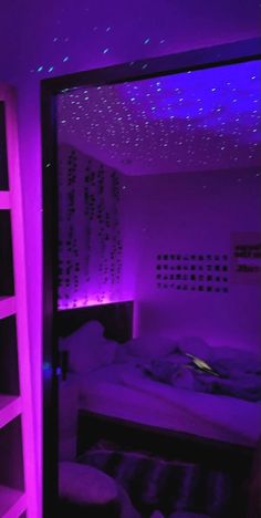 a bedroom with purple lighting and a bed