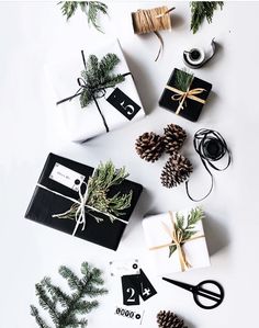 presents wrapped in black and white paper with pine cones