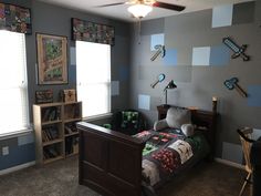 a bedroom with a bed, desk and bookcases on the walls is shown