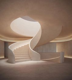 a spiral staircase in an empty room with light coming from the ceiling and lighting on the walls