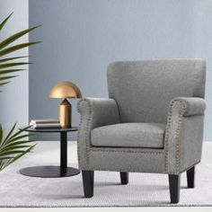 a gray chair and side table in a room