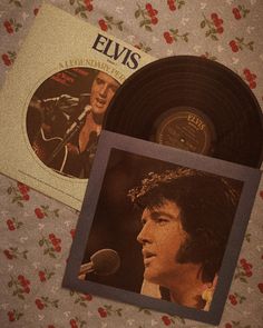 an elvis presley album and record sitting on a bed