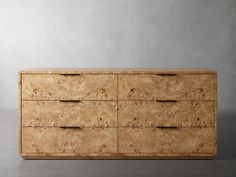 a large wooden dresser sitting on top of a gray floor next to a white wall