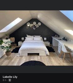 an attic bedroom with white furniture and black walls