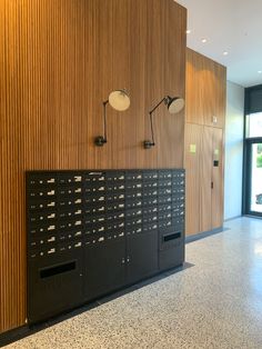 a wall with several mailboxes on it in an office building or conference room