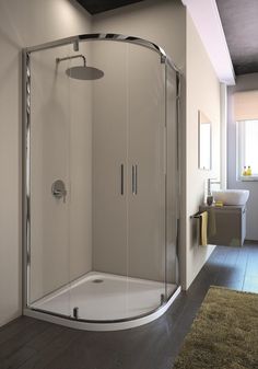 a bathroom with a walk in shower next to a rug