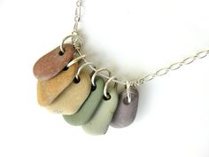 five different colored stones hanging from a silver chain