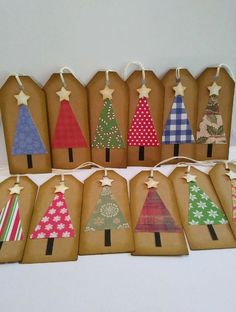 paper bags with christmas trees on them are lined up in different colors and shapes,