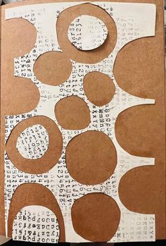 an open book with circles cut out of paper and some type of writing on it