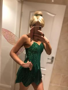 a woman is taking a selfie in the mirror wearing a green dress with sequins