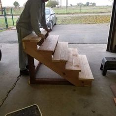 a man working on some stairs in a garage