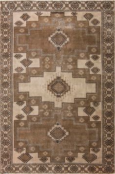 a brown and white rug with an intricate design on the bottom, in different colors