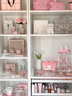 the shelves are filled with pink and white items