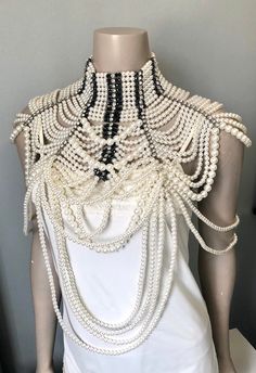 "Stunning faux pearl shoulder chain with rhinestone body jewelry. Details of loop faux pearls and rhinestones with 3 clasp and chain in back. Measurements: 18\" at longest point in front 2.5\" choker width 10\" off shoulder" White Pearl Body Jewelry With Pearl Chain, Pearl Beaded Body Chain For Wedding, Elegant White Body Jewelry For Evening, White Beaded Pearl Body Jewelry, Party Body Chain With Pearl Detail, Elegant Beaded Pearl Body Jewelry, Elegant White Body Jewelry With Pearl Chain, Elegant White Pearl Chain Body Jewelry, Glamorous Beaded Body Jewelry For Evening