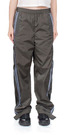 The 6397 side zip nylon pant bark offers both fashion and function. this water-resistant nylon ripstop pant features a relaxed straight leg and covered elastic waistband for all-day comfort. with side pockets and a blue stripe detail it's the perfect mix of sporty and stylish.    details:    - color: bark  - 100% nylon; lining: 100% polyester  - elasticated waistband  - zip pockets at sides  - side zippers at hem  - vendor code: np346  - fits true to size  - model is 5ft 5in and is wearing a size s Ripstop Pants, Denim Projects, Nylon Pants, Cute Jeans, Pocket Pants, Top Shoes, Designer Outfits Woman, Trousers Women, Blue Stripes