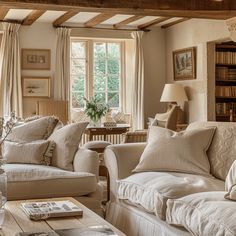 a living room filled with furniture and windows